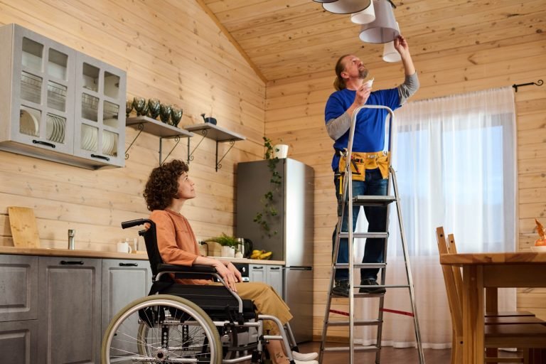 young-woman-with-disability-looking-at-electrician-2023-11-27-05-06-39-utc-min